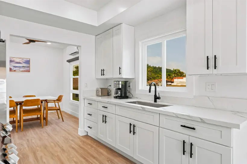 Bright kitchen interior featuring white countertops and cabinetry.
