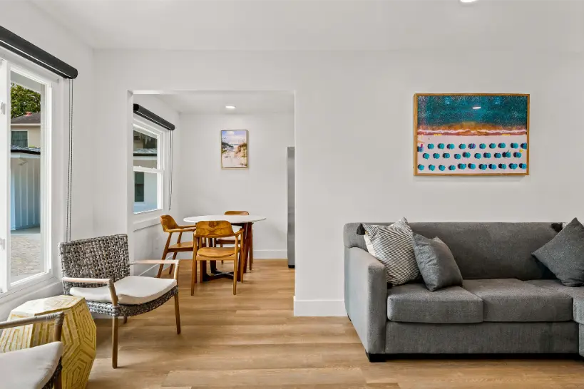 living room with a gray sofa and a small dining set.