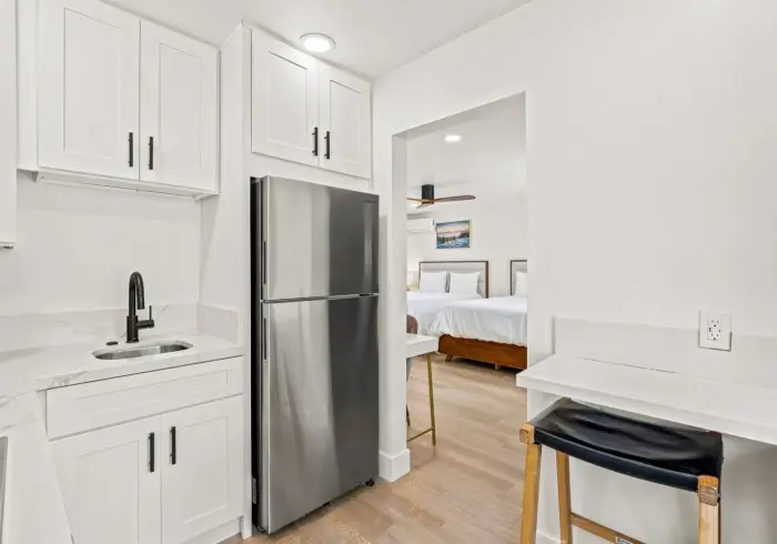 Kitchenette and refrigerator in Deluxe Queen suite.