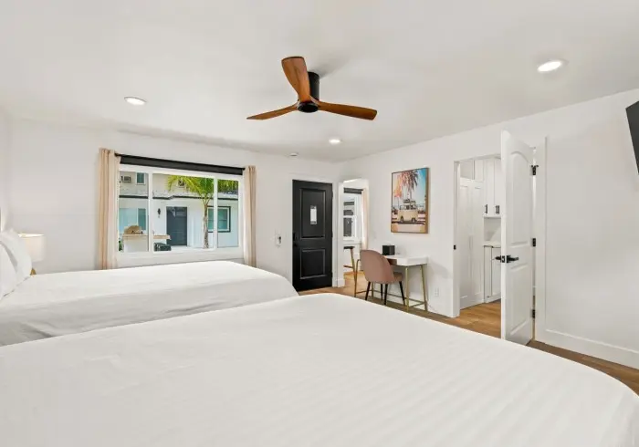 Bedroom view facing double beds in Deluxe Queen suite.