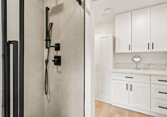 Walk-in shower and bathroom vanity in Deluxe Queen suite.