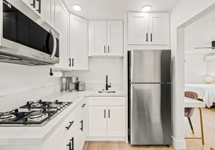 Fully equipped kitchen in Deluxe Queen suite.
