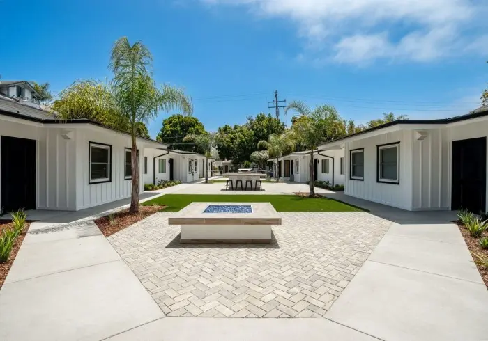 Outdoor courtyard and fire pit outside Deluxe Queen suite.