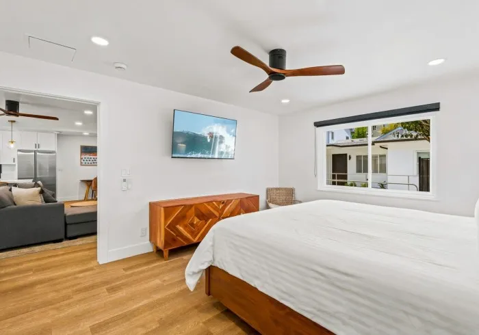 Penthouse bedroom with king bed and TV.