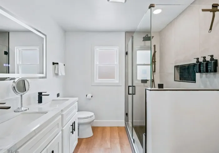 Penthouse bathroom with vanity, toilet, and glass shower.
