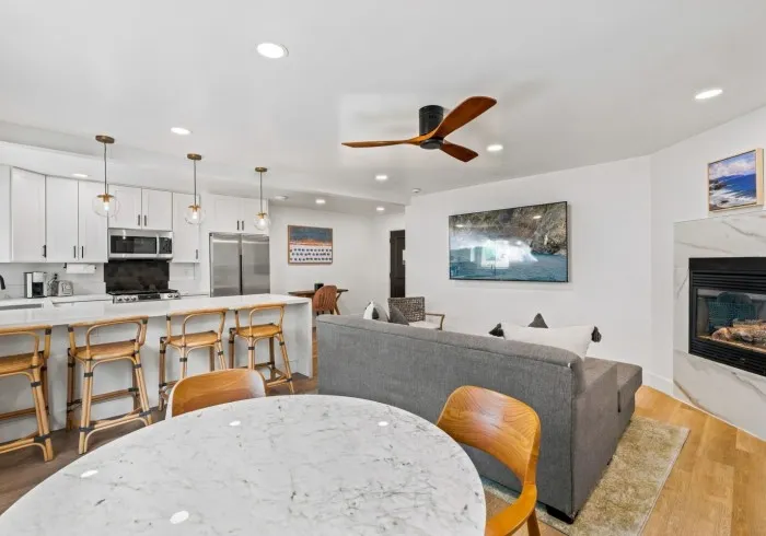 Penthouse open living space, dining table, and kitchen bar.