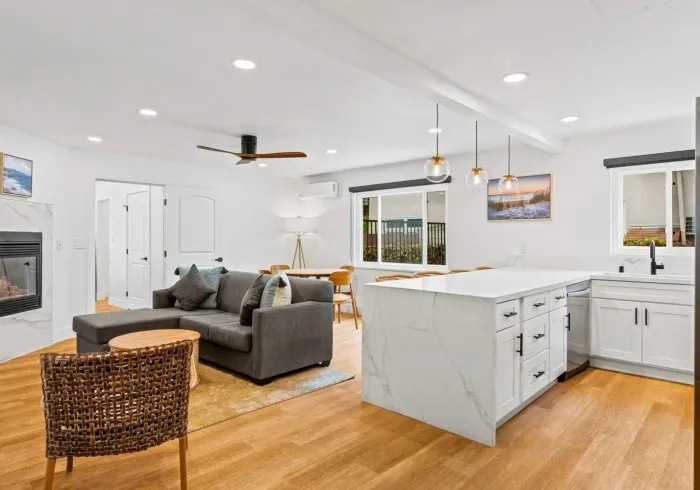 Wide shot of the open-plan Penthouse living area and kitchen.