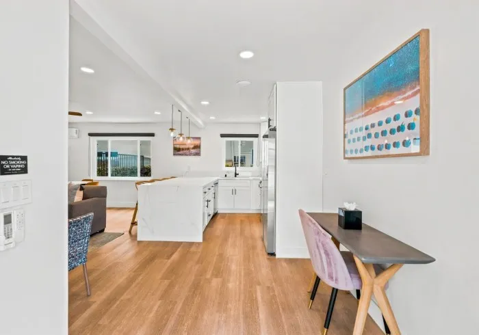 Penthouse hallway leading into open living area with work desk.