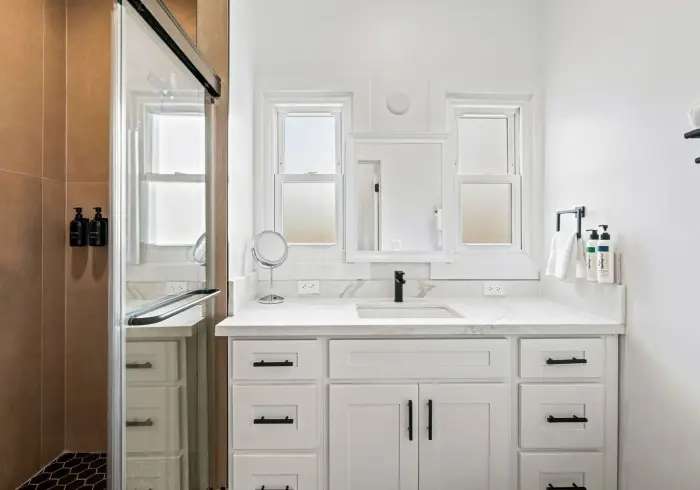 Bathroom vanity and mirror in Penthouse plus Studio.