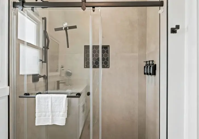 Walk-in glass shower stall in Penthouse plus Studio.