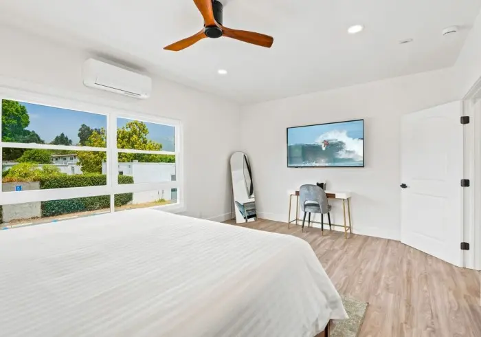 Spacious bedroom with large window in Penthouse plus Studio.