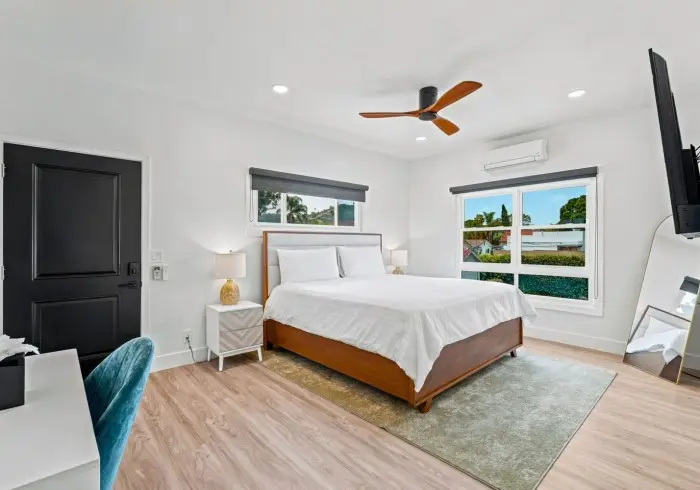 Bedroom with black door and desk area in Penthouse plus Studio.