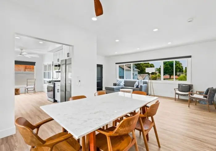 Open-concept dining table and living area in Penthouse plus Studio.