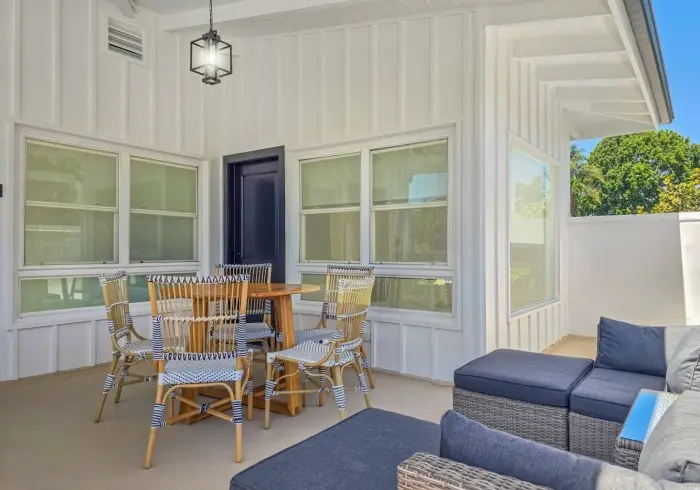 Covered outdoor patio with seating in Penthouse plus Studio.